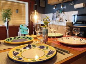 A dining table set with plates, glasses, and a vase with a plant. - Greenmist Atami Shizenkyo (Atami)