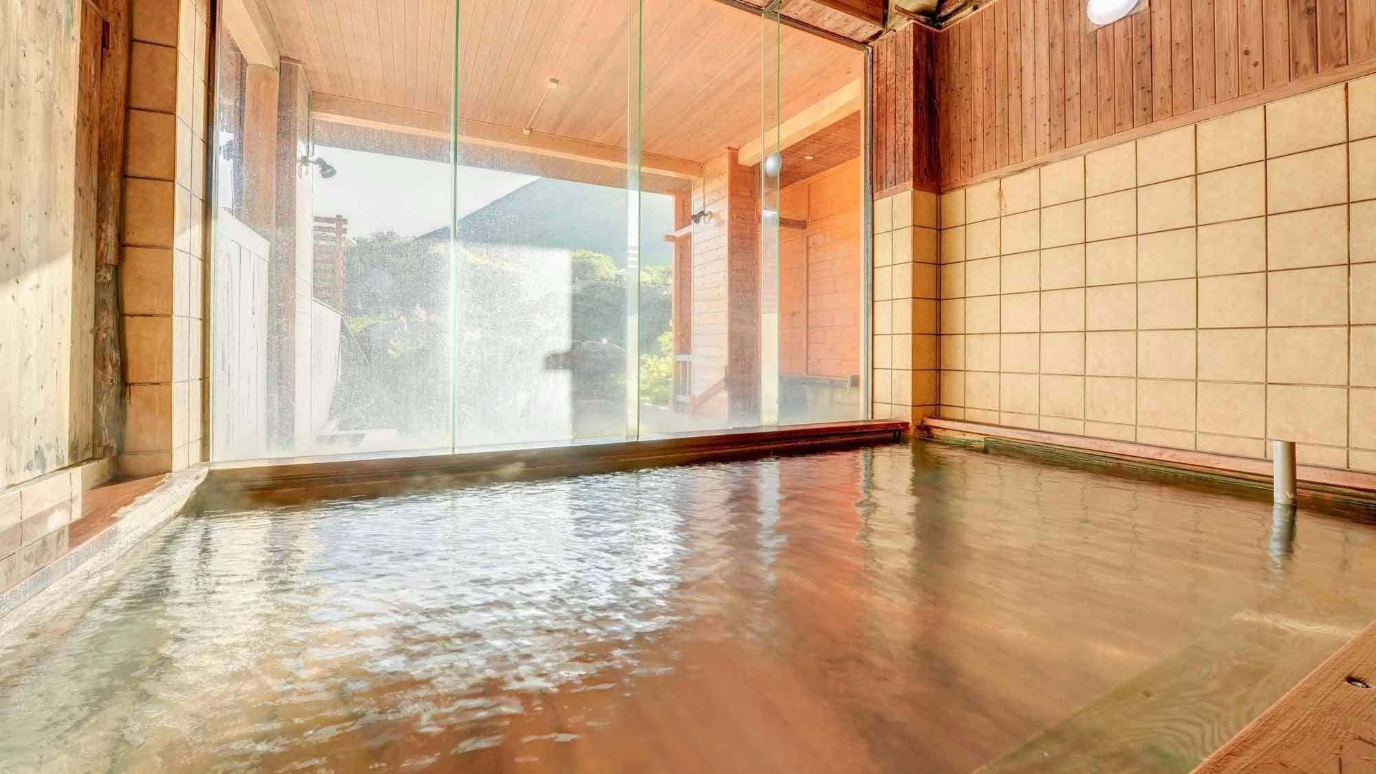 A traditional wooden bathhouse with a large open space and a view of the outside.