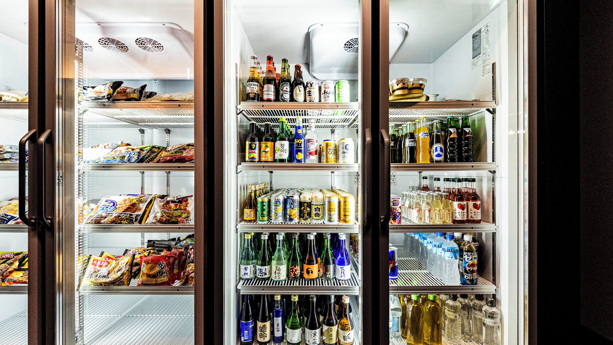 A refrigerated display case with various food items and beverages.