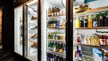 Three refrigerated display cases with various beverages and snacks.