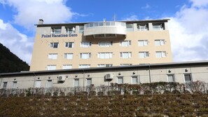 A multi-story building with a sign reading 'Point Vacation Gero'. - Point Vacation Gero (Gero)
