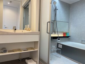 A modern bathroom with a sink, mirror, shower, and a towel rack. - Hotel Toin Kyoto (Kyoto)