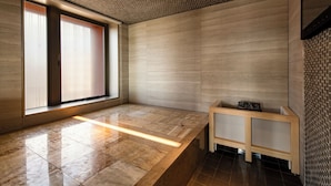 A modern room with a large window, a bench, and a wooden console table.