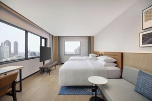 A hotel room with a large window, a bed, a sofa, a desk, and a TV. - Four Points By Sheraton Chongqing Yuzhong Peninsula (Chongqing)