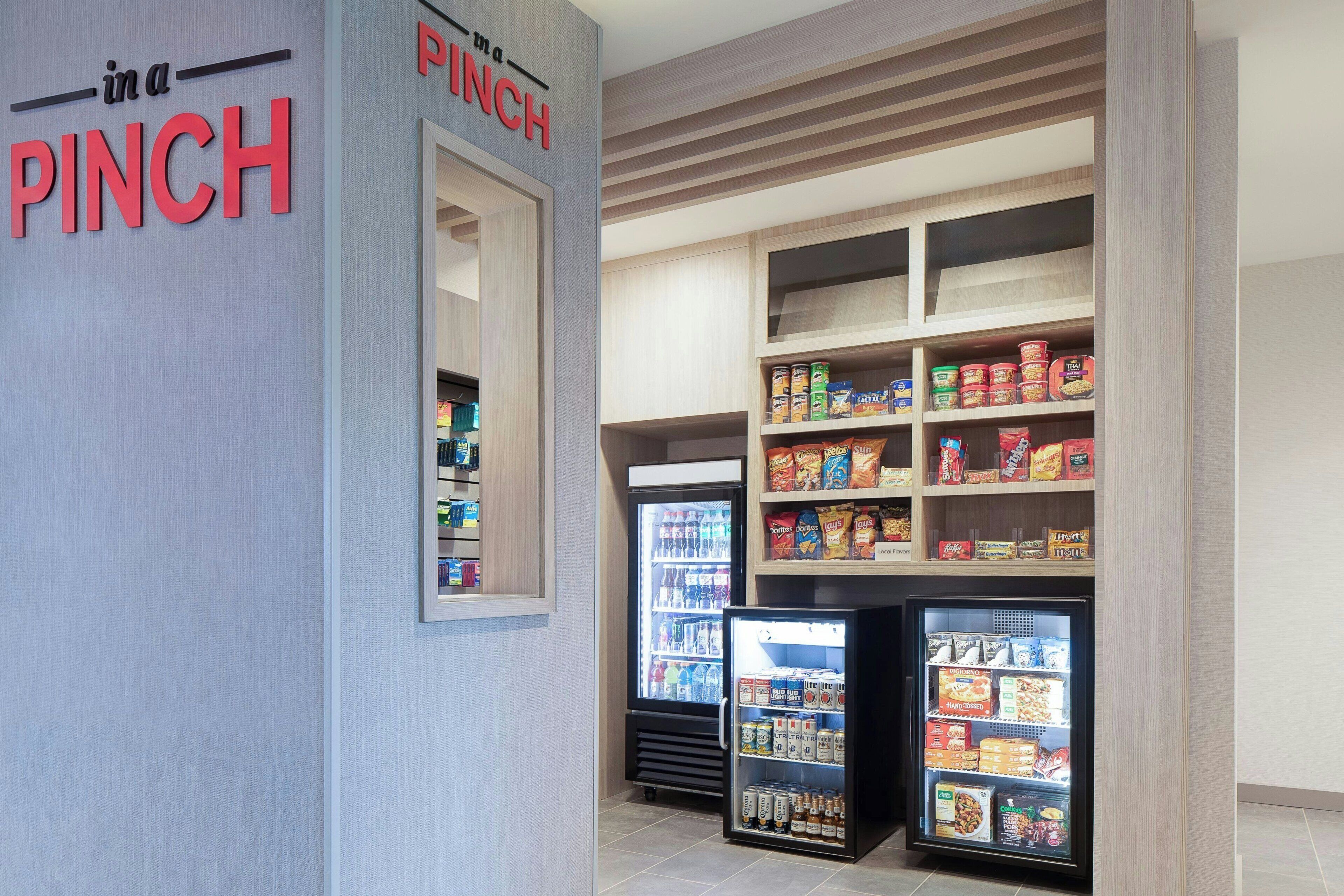 A snack and beverage vending area with a sign reading 'in a PINCH'.