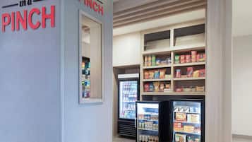 A snack and beverage vending area with a sign reading 'in a PINCH'.