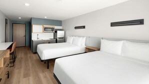 A hotel room with two beds, a desk, a chair, a microwave, and a small kitchenette. - StudioRes by Marriott Mesa (Mesa)