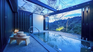 A modern outdoor pool area with a glass enclosure, a wooden deck, and a view of the surrounding landscape. - Momijiya Of Takao Kyoto (Kyoto)