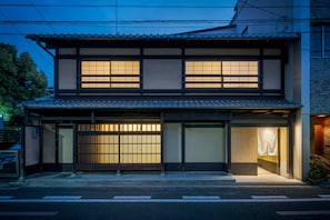 A traditional Japanese building with a tiled roof, large sliding doors, and a wooden gate. - Anjin Gosho Ebisugawa (Kyoto)
