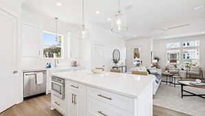 A spacious kitchen with white cabinetry, a large island, and pendant lighting. - Walk to Beach in Blue Mtn! Private Pool, LSV/Golf Cart, & Bikes! Sleeps 17! (Santa Rosa Beach)