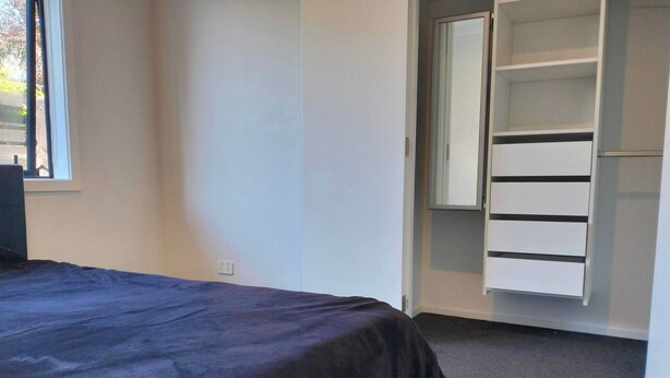 A bedroom with a bed, a wardrobe, and a window. - Room-quite and Cozy Double Bedroom (Christchurch)