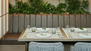 A dining area with booths, a plant wall, and a neutral color scheme. - Fufu Karuizawa (Karuizawa)
