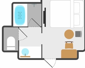 Une pièce comprenant un lit, un bureau, une chaise, une petite table et un radiateur.