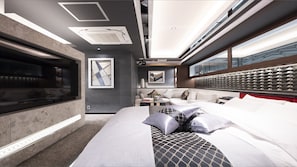 A modern hotel room with a large bed, a seating area, and a view through the window. - Hotel Kabuki (Tokyo)