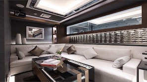 A modern living room with a sofa, a glass coffee table, and a large window with a view of a building. - Hotel Kabuki (Tokyo)