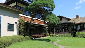 A traditional Japanese-style building with a wooden exterior and a well-maintained garden. - Atami Onsen Umibe no Yado Nagahamaen (Atami)