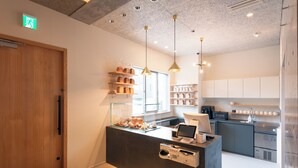 A modern kitchen with a central island, built-in shelves, and pendant lighting.
