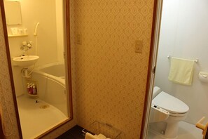 A bathroom with a bathtub, toilet, and sink.