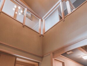 A corner of a room with a sloped ceiling and a window. - Wakamatsu Ryokan (Hakodate)