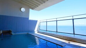 An indoor swimming pool with a view of the ocean. - Wakamatsu Ryokan (Hakodate)