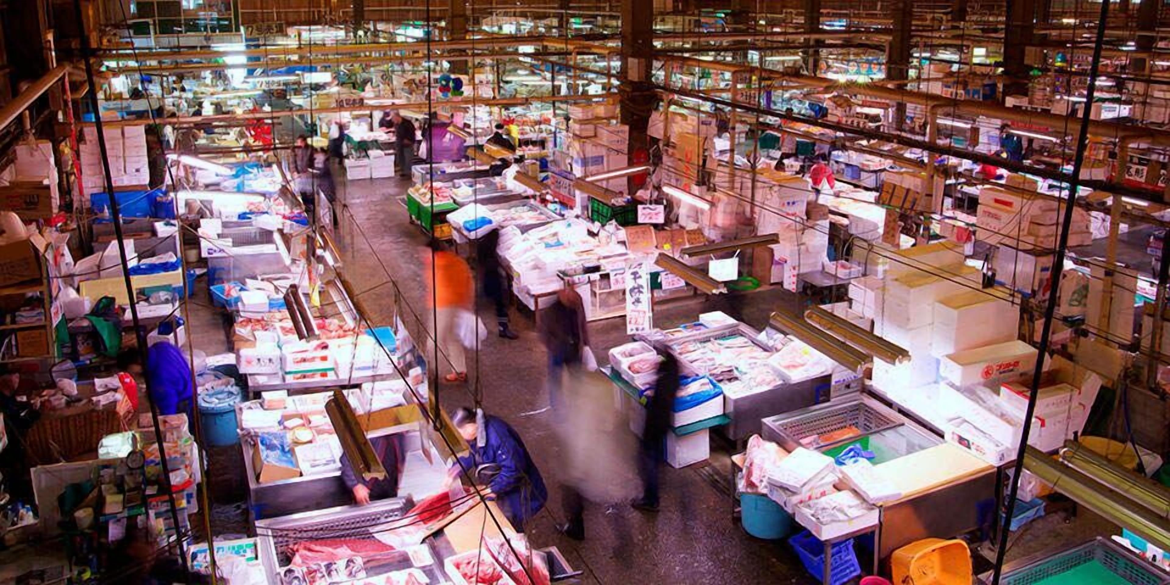 A busy indoor market with various stalls and goods.