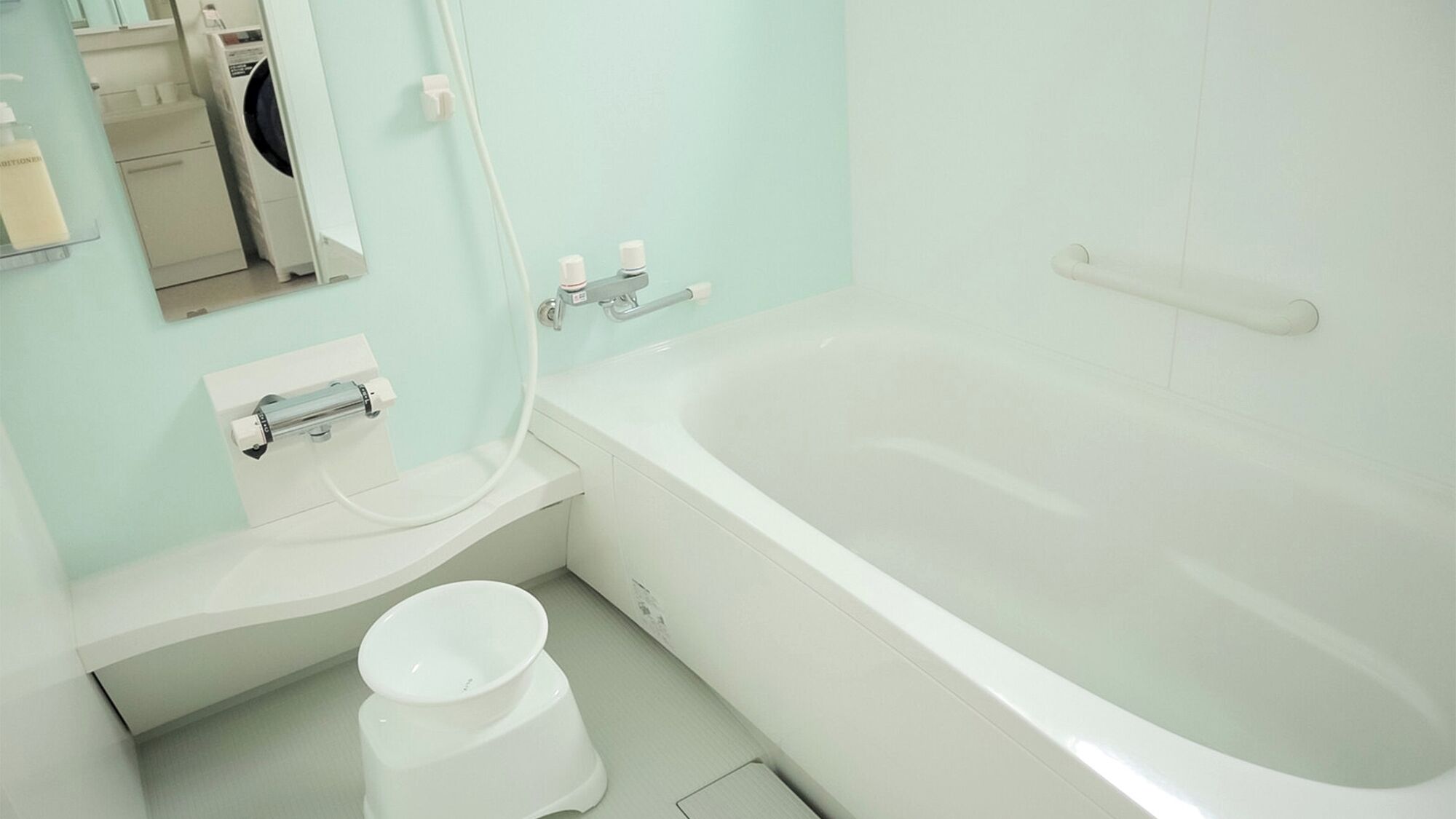 A bathroom with a bathtub, toilet, and sink.