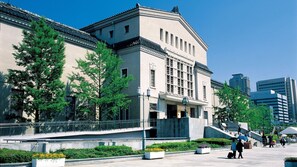 A building with a classical architectural style, featuring a prominent entrance, a balcony, and a staircase leading to the entrance. - Osaka International Center Hotel Uehommachi (Osaka)