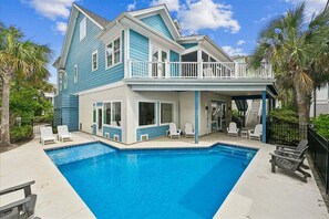 A two-story house with a pool, a balcony, and a covered patio area. - Impressive Game Room, Pool, Steps to Beach, Great Location, Free Golf (Hilton Head Island)