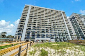 A multi-story hotel with balconies, a beach view, and a wooden boardwalk. - Gulf Front-Heart of Destin-Lots of Amenities! Sundestin 209 (Destin)