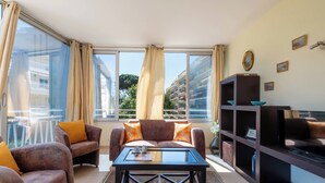 A living room with a sofa set, a coffee table, and a TV stand. - Bright 2-Bedroom Apartment – Close to La Croisette & City Centre (Cannes)