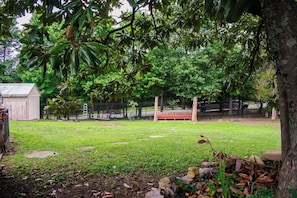 A fenced yard with a wooden bench, a small shed, and a ladder leaning against the fence. - Fort Washington Retreat - 5 minutes to Gaylord & MGM (Fort Washington)