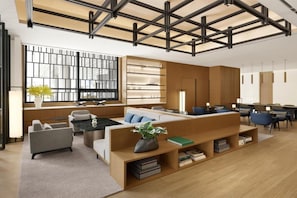 A modern interior with a sectional sofa, a coffee table, a bookshelf, and a dining area with chairs. - Courtyard Sejong (Sejong)