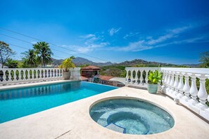 A pool with a hot tub, surrounded by a white balustrade, with a mountain view in the background. - Mariposita Marina Real #2 (Playa Flamingo)