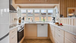 A modern kitchen with a dishwasher, oven, and large windows. - Gorgeous home in Otterup with WiFi (Otterup)