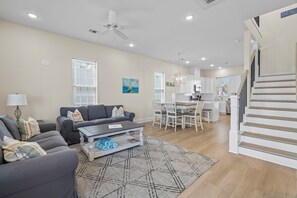 A living room with a sofa set, coffee table, and patterned rug. - Sunny Beachside Bungalow #10 Steps from the Sand in Galveston (Galveston)