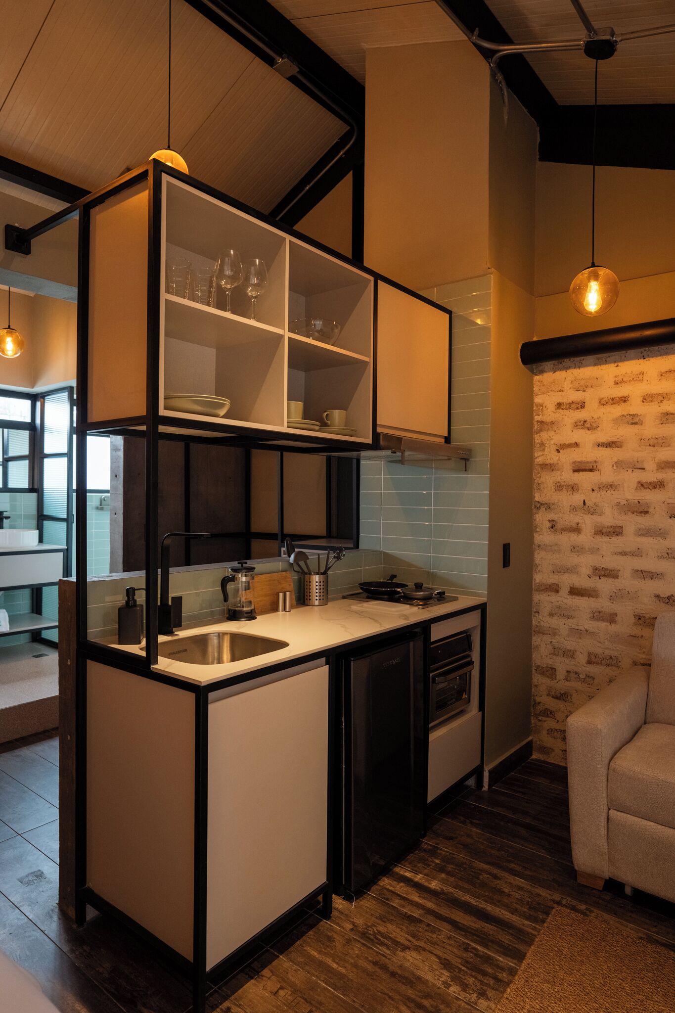 A compact kitchen with a built-in island, a sink, and a stove.