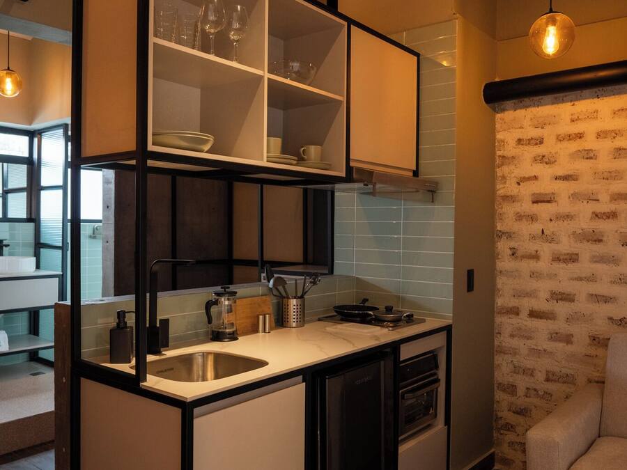 A compact kitchen with a built-in island, a sink, and a stove.