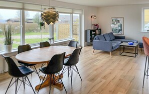 A modern living room with a dining area, large windows, and a view of the outdoors. - Awesome home in Faaborg with WiFi (Faaborg)