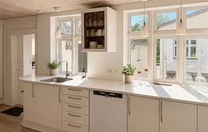 A kitchen with a large island, built-in cabinets, a dishwasher, and a window with a view. - 3 bedroom gorgeous home in Faaborg (Faaborg)