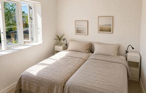 A bedroom with a bed, two bedside tables, a window, and two framed pictures on the wall. - 3 bedroom gorgeous home in Faaborg (Faaborg)