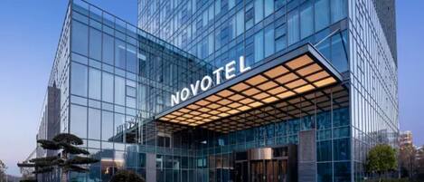 A modern hotel with a glass facade, a prominent entrance, and a well-maintained exterior.