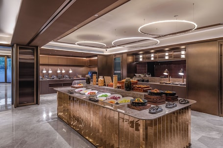 A modern kitchen with a central island, built-in appliances, and a sleek design.