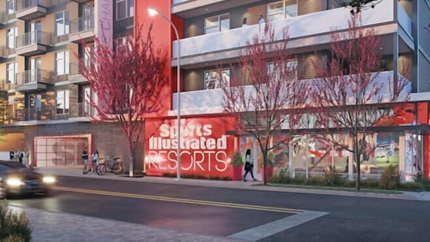 Un edificio de varios pisos con un llamativo letrero rojo de Sports Illustrated Resorts.