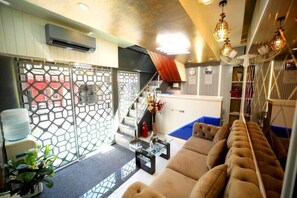 A modern interior with a sofa, a staircase, and a reception desk. - N.m. Hotel Mumbai (Mumbai)