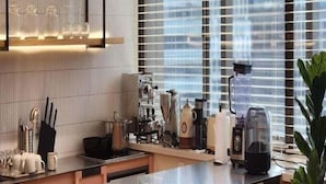 A modern kitchen with a central island, stainless steel appliances, and a large window with blinds. - Glocaloca Gwangwhamun (Seoul)