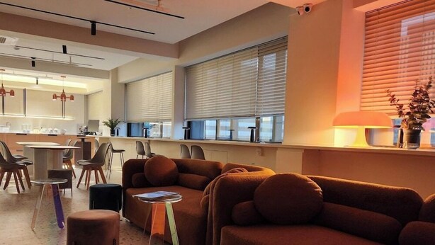 A modern living room with a sofa, chairs, a coffee table, and a kitchen area in the background. - Glocaloca Gwangwhamun (Seoul)