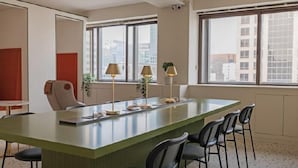 A modern hotel room with a large island table, multiple chairs, a sofa, and large windows offering a city view. - Glocaloca Gwangwhamun (Seoul)