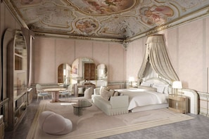 A luxurious bedroom with a canopy bed, a sitting area with a round table, and a large mirror.