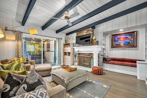 A living room with a fireplace, a television, and a sofa. - Serene 2BR Valley Glen Oasis: Private Yard, & BBQ (Los Angeles)