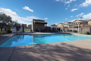 A swimming pool with a covered area, fenced surroundings, and a clear sky. - Spacious 4-bedroom house with office and loft in fabulous Tucson. (Tucson)